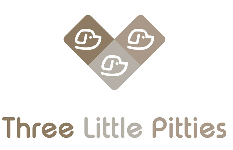 Logo for "Three Little Pitties" featuring three stylized dog faces in earthy tones with playful typography.